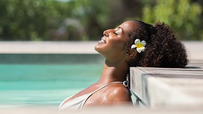 Beautiful african woman in pool relaxing