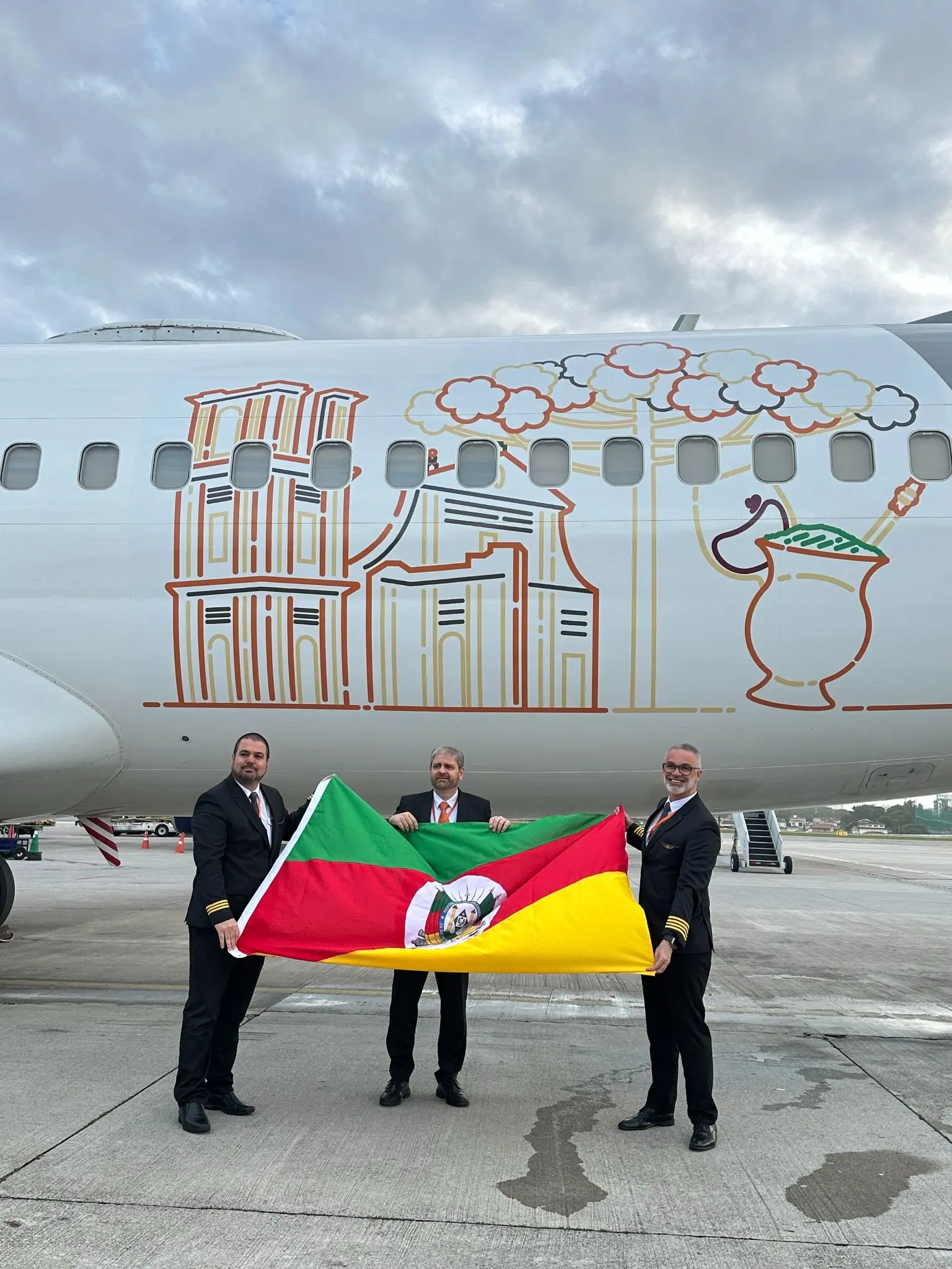 O voo de retomada da GOL rumo a POA, G3 1210, aconteceu a partir de Congonhas, às 7h00 desta segunda (21). Gaúchos na tripulação empunharam com orgulho a bandeira do Rio Grande do Sul durante o embarque. Da esq. para a dir., o copiloto Vinicius Brehm, o comissário Adriano Farina e o piloto Paulo Zancani (Foto: Divulgação GOL)