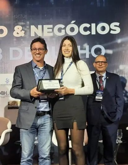 Flávia Dell Antônio recebe homenagem em nome de seu pai, o hoteleiro Estanislau Bresolin, que faleceu em 2022. A homenagem foi concedida na abertura do Encatho & Exprotel 2022, em Florianópolis-SC.