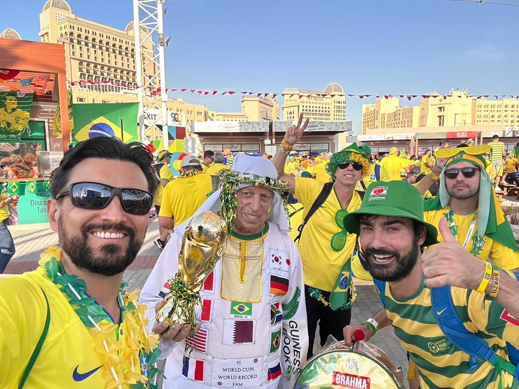 Daniel Sbruzzi (ao centro), recordista mundial de presenças em Copas do Mundo reconhecido pelo Guinness World Records, posa com a réplica da taça ao lado de torcedores brasileiros durante o Mundial. - Crédito: Divulgação / VIRA Assessoria Daniel Sbruzzi (ao centro), recordista mundial de presenças em Copas do Mundo reconhecido pelo Guinness World Records, posa com a réplica da taça ao lado de torcedores brasileiros durante o Mundial. - Crédito: Divulgação / VIRA Assessoria